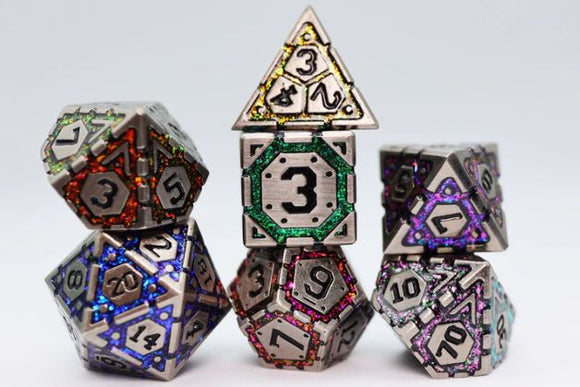 Four intricately designed metal RPG dice with colorful accents arranged in a playful stack. The dice feature varying geometric shapes and numbers, showcasing vivid hues of purple, green, red, and blue, perfect for tabletop gaming enthusiasts.