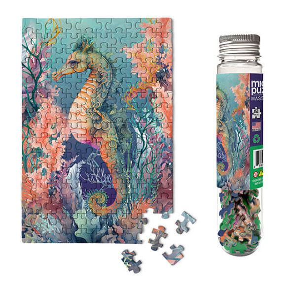 Seahorse - Marine Life Micro P jigsaw puzzle featuring a colorful underwater scene with a detailed illustration of a seahorse surrounded by corals. The puzzle pieces are displayed around the image along with a cylindrical container holding the pieces.