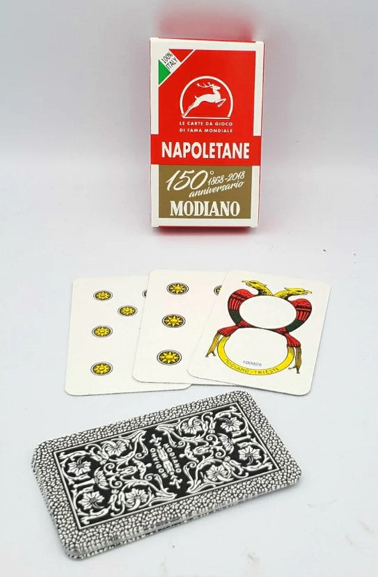 A pack of NAPOLETANE Italian playing cards by Piatnick, featuring colorful illustrated cards and a decorative card back design. The pack is housed in a vibrant red and white box celebrating 150 years of Modiano.