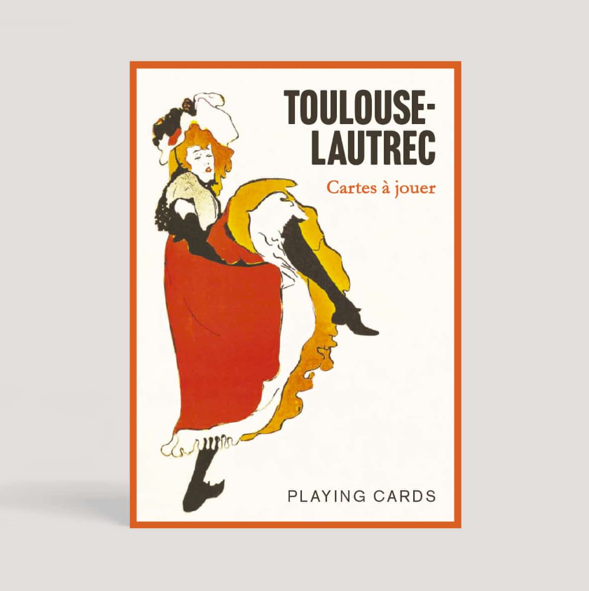 A visually striking box design featuring Toulouse-Lautrec inspired artwork for a deck of playing cards. The illustration shows a woman in a red dress with a flowing skirt, highlighting the elegance and charm of the design. The top of the box has the title 'TOULOUSE-LAUTREC' and the phrase 'Cartes à jouer' in a stylish font, with 'PLAYING CARDS' prominently displayed at the bottom.