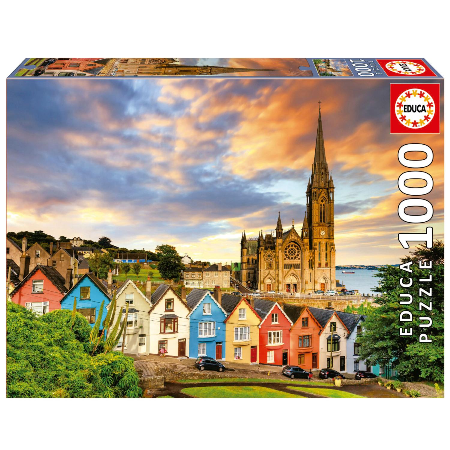 Educa jigsaw puzzle featuring Cobh Cathedral in Ireland, with colorful houses in the foreground and a vibrant sunset sky. The puzzle has 1000 pieces, showcasing stunning architecture and scenic views.