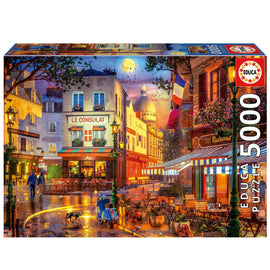 Educa jigsaw puzzle titled 'Le Consulat', featuring a vibrant scene of a Parisian street with cozy cafes, a glowing moon, and animated street life, perfect for puzzle enthusiasts. Contains 5000 pieces that capture the charm of Paris.