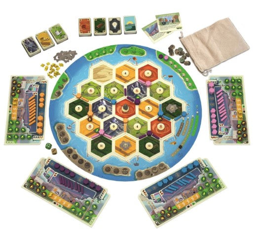 Catan: New Energies board game featuring a circular game board with hexagonal territories, resource cards, and various player pieces. The board is surrounded by player boards in different colors, and there are resource tokens and cards displayed on the sides of the board.