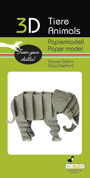 A 3D paper model kit of a gray elephant, featuring intricately designed folds that form its body. The model is displayed against a vibrant green and black background, showcasing the layered structure of the paper and its artistic appeal. It is part of a DIY kit made by Fridolin, aimed at encouraging creativity and hands-on crafting.