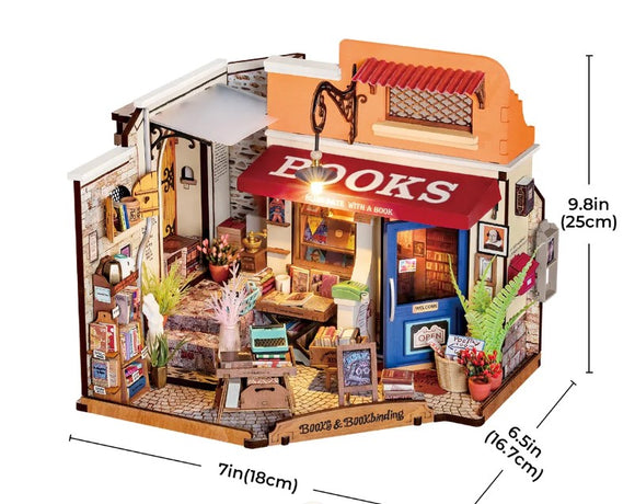 A beautifully detailed DIY kit titled 'Corner Bookstore' by Robotime, featuring an intricately designed miniature bookstore scene. The model showcases a cozy shopfront with a red awning labeled 'BOOKS', surrounded by shelves filled with books, potted plants, and decorative items. The interior includes a small table, artwork on the walls, and a charming open sign at the door. Perfect for crafting enthusiasts who enjoy building miniature models.