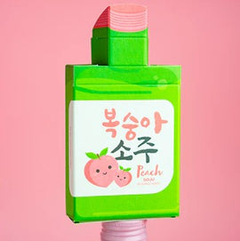 Peach SOJU Playing Cards featuring a vibrant green packaging design that resembles a peach-flavored SOJU bottle. The front showcases cute illustrations of smiling peaches and playful lettering in Korean and English, making it an eye-catching addition to any game collection.