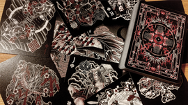 A close-up view of Sumi Original Craft Playing Cards spread out, showcasing intricate black and white artwork with hints of red. The deck features unique designs on each playing card, featuring mythical and traditional motifs, laid beside the embossed card box.