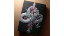 A beautifully illustrated box for Sumi Original Craft Playing Cards, featuring a striking dragon design intertwined with flames and a sword, set against a solid black background. The artwork is detailed and vibrant, showcasing the artistry that defines Card Experiment's unique playing cards.