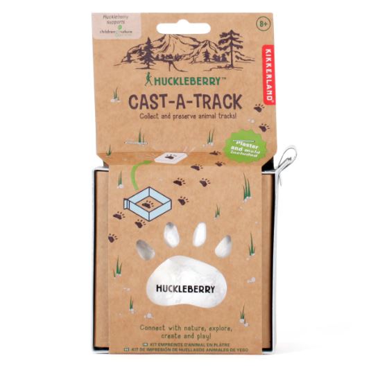 The Huckleberry Cast-A-Track kit by Kikkerland, featuring packaging that showcases a mountain scene with animal footprints. The kit includes materials for collecting and preserving animal tracks, inviting users to explore nature and engage in creative play.