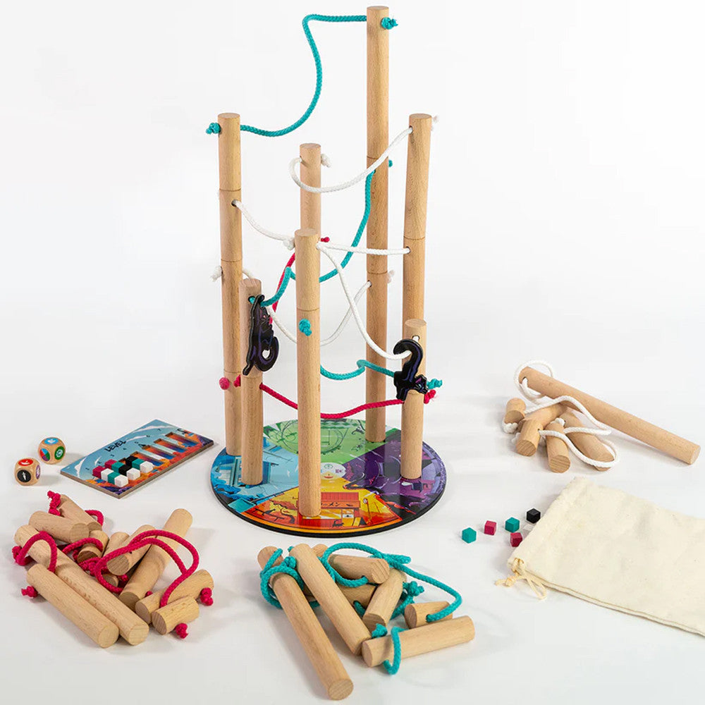 Nekojima game by Unfriendly Games featuring a vibrant, multi-colored base with vertical wooden poles wrapped in colored ropes. The game includes various wooden pieces, dice, and a small bag, designed for interactive play and skill-building.