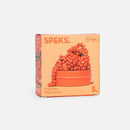 Crags Mini: Matte Coral by SPEKS is a vibrant orange box containing magnetic fidget putty. The putty is displayed as playful, piled shapes on top of a circular container. The packaging features a bold design with product information, designed to engage users who enjoy tactile and stress-relief toys.