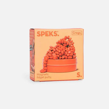 Crags Mini: Matte Coral by SPEKS is a vibrant orange box containing magnetic fidget putty. The putty is displayed as playful, piled shapes on top of a circular container. The packaging features a bold design with product information, designed to engage users who enjoy tactile and stress-relief toys.
