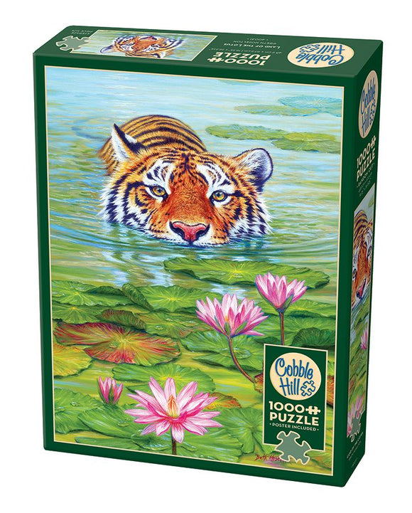 Cobble Hill 'Land of the Lotus' jigsaw puzzle featuring a vibrant illustration of a tiger peering out of a tranquil pond surrounded by pink water lilies and lush lily pads. The puzzle contains 1000 pieces and includes a poster for reference.