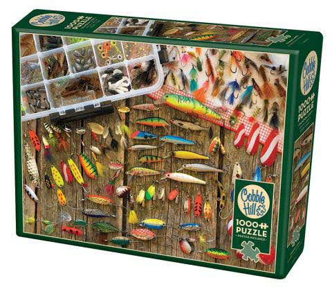 Cobble Hill Fishing Lures jigsaw puzzle featuring a detailed image of various fishing lures displayed on a rustic wooden board. The puzzle box artwork showcases bright colors and intricate designs of the lures, with a variety of shapes and patterns, perfect for fishing enthusiasts and jigsaw puzzle lovers alike.