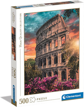 Clementoni Flavian Amphitheatre jigsaw puzzle packaging featuring a stunning image of the amphitheater at sunset, surrounded by vibrant flowers and greenery. The box displays a total of 500 pieces and is designed for puzzle enthusiasts.