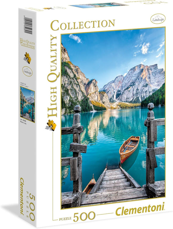 A beautifully designed 500-piece jigsaw puzzle box featuring an image of Braies Lake. The puzzle showcases a serene landscape with mountains in the background, a wooden dock leading to the tranquil turquoise waters, and a small wooden boat gently floating. The box design highlights the high-quality collection by Clementoni.