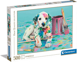 Box of 'The Funny Dalmatian' jigsaw puzzle by Clementoni featuring a colorful, painted Dalmatian puppy lying beside paintbrushes and a paint can. The box shows vibrant artwork with a playful theme, ideal for animal lovers and puzzle enthusiasts.
