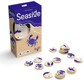 Seaside game by RANDOLPH, featuring circular wooden tokens illustrated with various seaside creatures like crabs and shells. The box is designed with playful blue and beige graphics, embodying a beach theme.