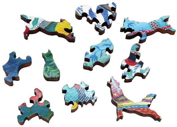 A vibrant collection of wooden jigsaw puzzle pieces from the artwork 'Recharging' by Emily Carew Wood. The pieces feature colorful designs, including animals and abstract shapes, highlighting craftsmanship and artistic expression.