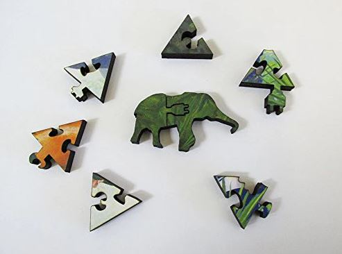 A colorful ensemble of jigsaw puzzle pieces featuring a central green elephant and various triangular and abstract shapes. The pieces showcase a vibrant mix of colors and intricate designs, making it visually appealing for puzzle enthusiasts.