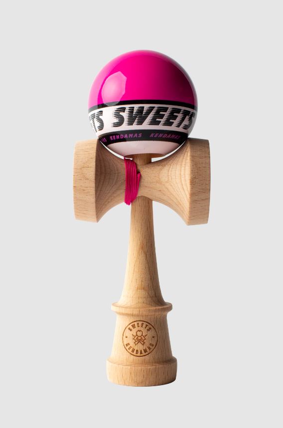 A vibrant pink Kendama toy, crafted by Sweets Kendamas. The smooth, glossy pink ball is attached to a wooden handle with a traditional look, featuring a logo embossed on the base. This skill toy encourages coordination and creative play.