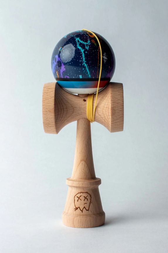 Cody Griz Signature Kendama crafted by Sweets Kendamas. Features a beautifully designed globe with a cosmic pattern atop a wooden handle. The kendama has a unique string loop and an engraved ghost design on the base, ideal for skill and coordination games.