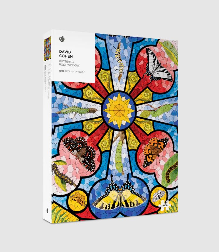 A colorful jigsaw puzzle titled 'Butterfly Rose Window' by David Cohen, featuring a vibrant stained glass design with butterflies and caterpillars, packaged in a sturdy box. The puzzle contains 1000 pieces, ideal for enthusiasts and art lovers looking for a creative challenge.