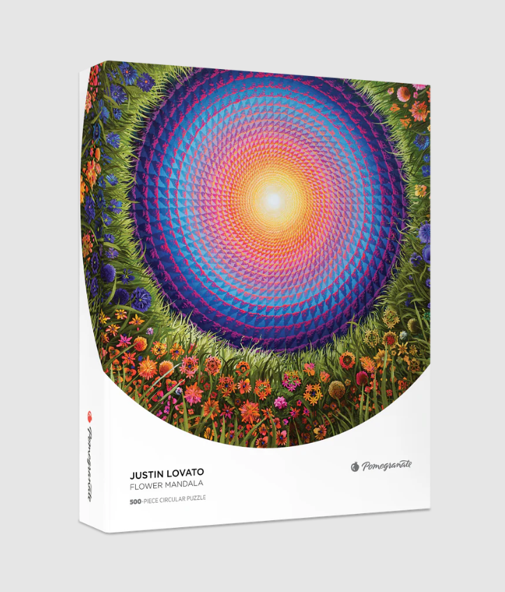 A beautifully designed jigsaw puzzle titled 'Flower Mandala' by Justin Lovato, featuring a vibrant circular pattern with colors transitioning from blue to purple to orange, surrounded by colorful flowers and green grass. The box displays the artwork prominently, emphasizing its intricate details and artistic flair. Suitable for puzzlers of all ages, this 500-piece puzzle promises a delightful challenge.