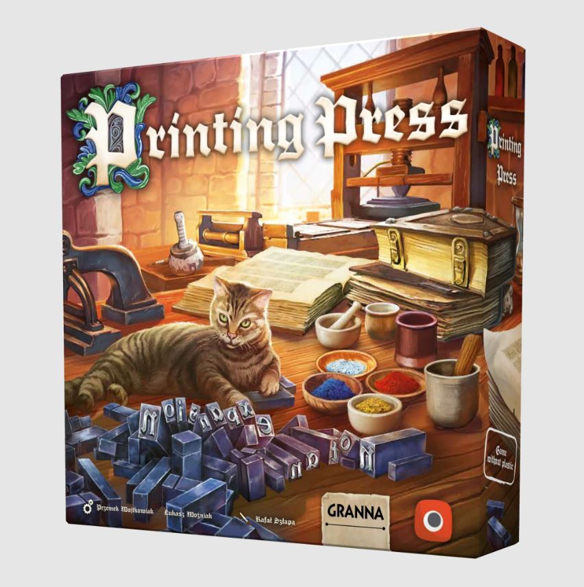 A colorful box of the game 'Printing Press' by Portal Games, featuring an illustration of a cozy workspace with a cat lounging on the table. The scene includes wooden printing tools, scattered letterpress blocks, and several containers holding colors, set against a bright window.