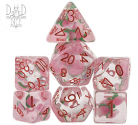 A vibrant set of seven polyhedral RPG dice featuring a peach theme. The dice are translucent with peach illustrations and red numbering, resembling a farmer's market aesthetic, perfect for tabletop gaming enthusiasts.