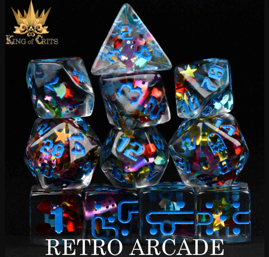 A vibrant Retro Arcade 11pc RPG Dice Set by King of Crits displayed against a black background. The set includes various polyhedral dice featuring colorful, holographic designs with numbers and playful arcade-related motifs, perfect for tabletop gaming enthusiasts.