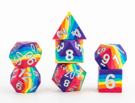 A colorful set of rainbow sharp edge silicone dice from FanRoll. The collection features various shapes, including a pyramid and different polyhedral dice, all adorned with metallic silver numbers. Their vibrant design and unique form make them a fun addition to board games and tabletop RPGs.