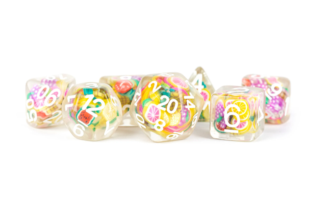 A colorful set of Fruit RPG Dice by FanRoll, featuring translucent resin with vibrant fruit designs embedded inside. The numbers are clearly printed in white on each die, creating a playful and eye-catching look perfect for tabletop gaming enthusiasts.