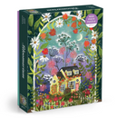 The Bloomarium Jigsaw Puzzle by Galison features a vibrant illustration with a charming yellow house surrounded by colorful flowers, plants, and a starry sky. It has 1000 pieces and promises an engaging puzzle experience for all ages.