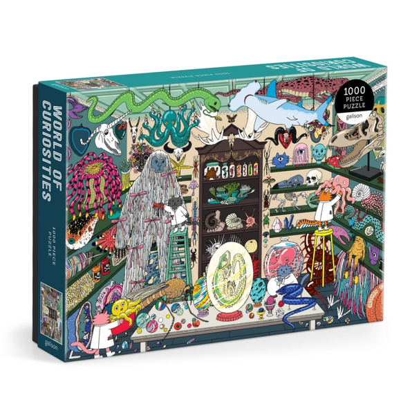 The World of Curiosities jigsaw puzzle by Galison features a whimsical illustration filled with colorful, intricate images of various curiosities and oddities. The scene includes playful characters interacting with fascinating sea creatures and an array of peculiar specimens displayed in vibrant detail.