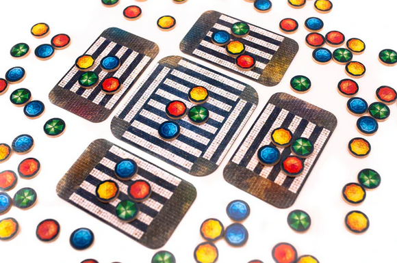 An engaging board game titled 'Umbrella' by PANDASAURUS GAMES featuring colorful tokens and striped game cards arranged on a white background. The image showcases the vibrant game components, perfect for family fun and strategic gameplay.