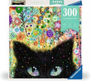 A colorful jigsaw puzzle box titled 'Kaleidoscope Kitty' by Ravensburger, featuring an artistic design of a black cat's face with vibrant green eyes, surrounded by a burst of flowers and patterns in multiple colors. The box indicates it contains 300 pieces.