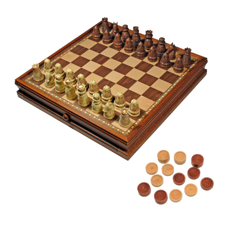 Medieval 15-inch chess set by Wood Expressions featuring intricately designed carved wooden pieces. The chessboard is made of rich wood tones with a classic checker pattern, and is designed to slide open for convenient storage of the pieces. Additional circular tokens are displayed beside the board.