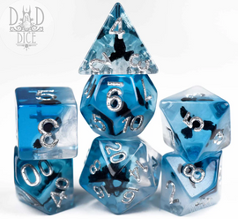 Dark Wings 7-piece RPG dice set featuring dice in various shapes and sizes. Each die is made of translucent blue material with silver metallic numbers and intricate dark wing designs. The set includes a twenty-sided die, a ten-sided die, and more, perfect for tabletop gaming enthusiasts.