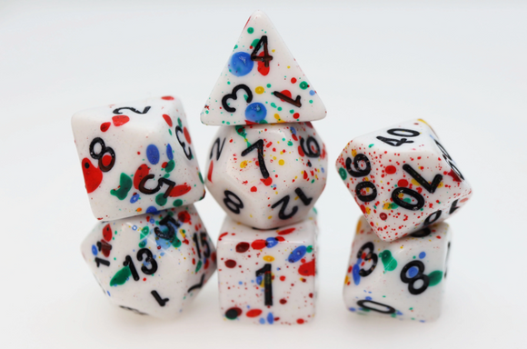 A colorful Paint Splatter RPG Dice Set featuring six polyhedral dice in various shapes, showcasing vibrant splashes of red, blue, green, and yellow against a white background. The numbers are clearly visible, making them ideal for tabletop role-playing games.