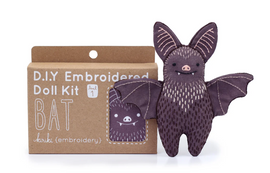 The Bat Doll Embroidery Kit by Kiriki Press is a DIY craft kit featuring a cute bat doll with embroidered details. The kit comes in a cardboard box labeled 'D.I.Y Embroidered Doll Kit' and includes everything needed to create this adorable plush bat, perfect for crafters and enthusiasts alike.