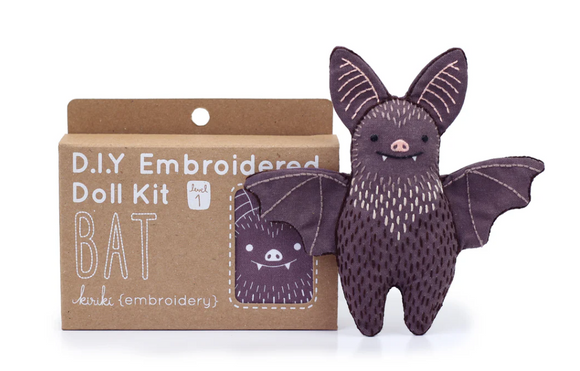 The Bat Doll Embroidery Kit by Kiriki Press is a DIY craft kit featuring a cute bat doll with embroidered details. The kit comes in a cardboard box labeled 'D.I.Y Embroidered Doll Kit' and includes everything needed to create this adorable plush bat, perfect for crafters and enthusiasts alike.