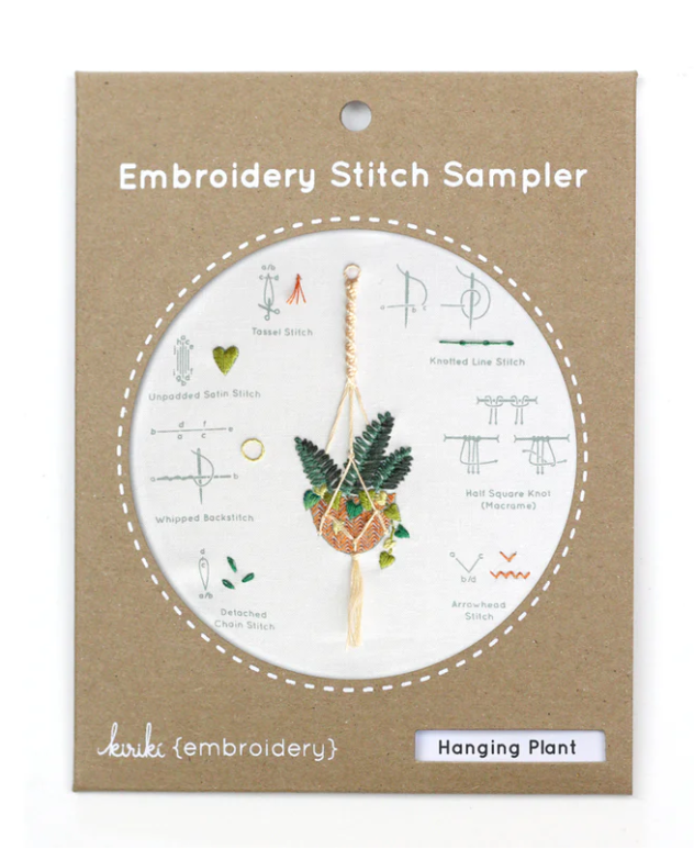 Hanging Plant Embroidery Stitch DIY kit by Kiriki Press. The kit includes a beautifully illustrated stitch sampler featuring a hanging plant motif, surrounded by various embroidery stitch techniques. Perfect for crafters to learn and create stunning embroidery.