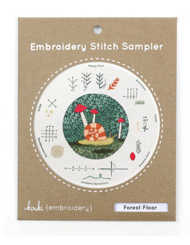 Forest Floor Embroidery Stitch kit by Kiriki Press, featuring a colorful snail surrounded by lush greenery and various stitch patterns for DIY embroidery projects.