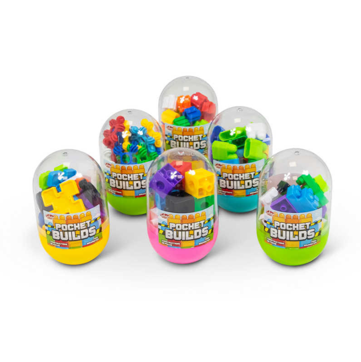 A colorful assortment of Pocket Builds kits by One for Fun, displayed in transparent egg-shaped containers. Each kit features a variety of small, colorful building pieces including blocks, flowers, and other fun shapes, designed for creative play and construction.