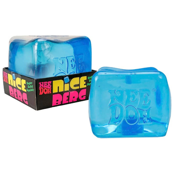 The Nee Doh Nice Berg Blue is a squishy, stress-relief toy featuring a solid blue cube design. It is packaged in a colorful box labeled 'Nee Doh Nice Berg' with bright pink and yellow lettering, promoting its super solid and squishy properties, ideal for sensory play and relaxation.