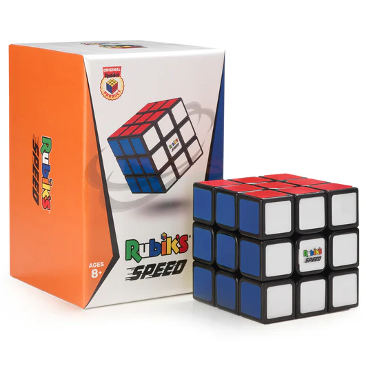 A Rubik's Cube from Spin Master, featuring vibrant red, blue, white, and orange colors. The cube is displayed next to its colorful packaging, designed for ages 8 and up. The packaging has the logo prominently displayed and highlights its speed cubing attributes.