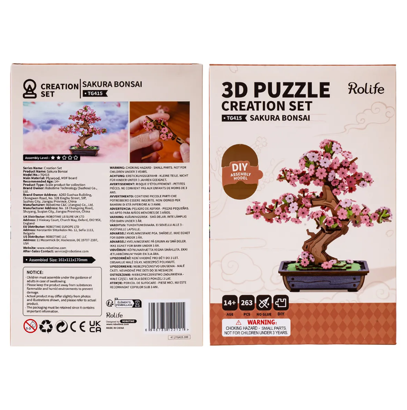 Sakura Bonsai Model DIY kit by Robotime. The packaging shows vibrant imagery of the completed bonsai tree adorned with pink blossoms. It highlights the 3D puzzle creation set consisting of 263 pieces, along with assembly instructions and noted choking hazard warnings. Ideal for ages 14 and up, providing a creative and engaging hands-on experience in building this decorative piece.