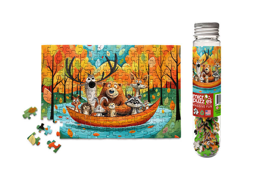 Canoe Critters Micropuzzle by Micro Puzzle, featuring a colorful jigsaw illustration of various woodland animals in a canoe on a vibrant lake surrounded by autumn trees. The completed puzzle is displayed alongside the clear container it comes in, filled with the small puzzle pieces.