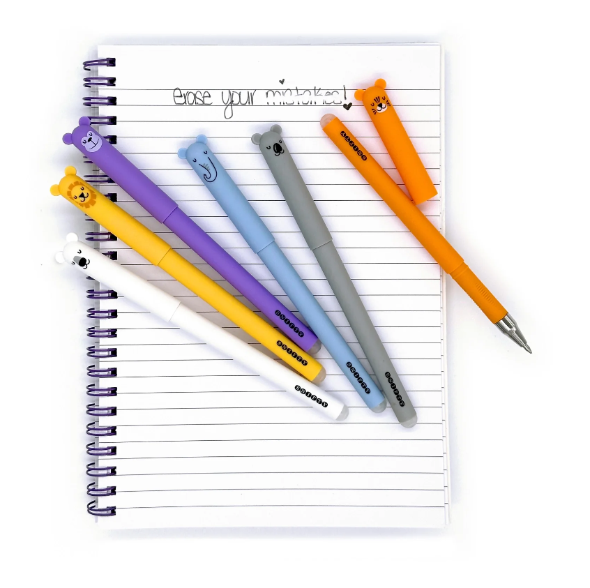 A vibrant assortment of Snifty Wild Life Erasable Pens featuring cute animal designs on top. The pens are displayed on a notepad with handwritten text that says 'Erase your mistakes!'. The assortment includes colors such as orange, purple, blue, yellow, gray, and white, showcasing a playful and whimsical aesthetic.